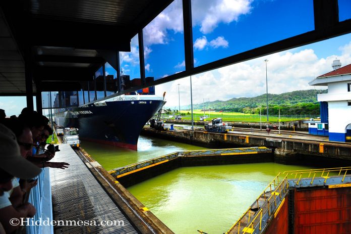 Gatun Locks Panama Canal A cargo ship being pulled through the Gatun Locks Panama Canal